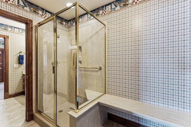 full bathroom featuring tile patterned floors, a shower stall, and wallpapered walls