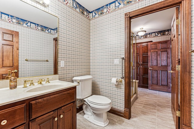 bathroom with tile patterned floors, vanity, toilet, and wallpapered walls