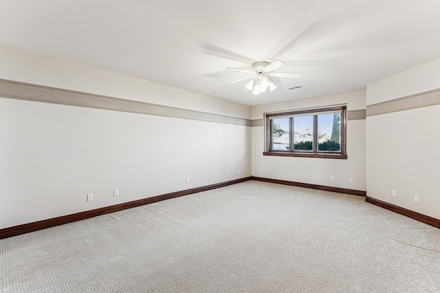 unfurnished room featuring light carpet, ceiling fan, visible vents, and baseboards