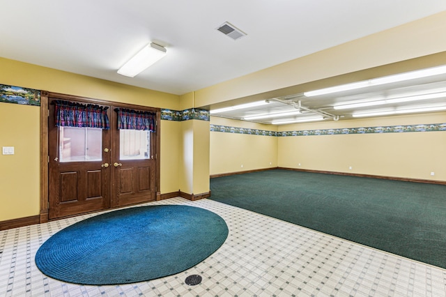 foyer featuring carpet flooring, visible vents, and baseboards