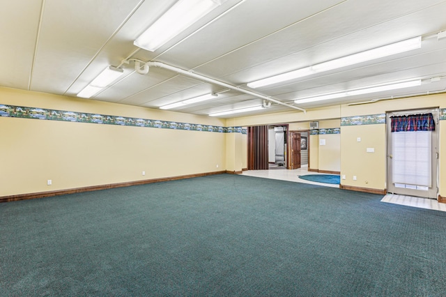 unfurnished room with carpet floors and baseboards