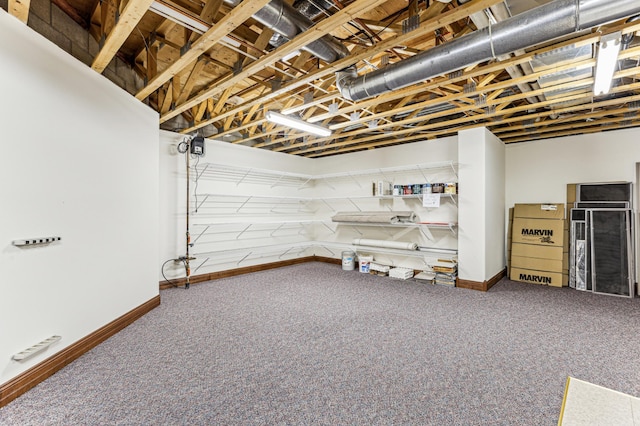 basement featuring carpet flooring and baseboards