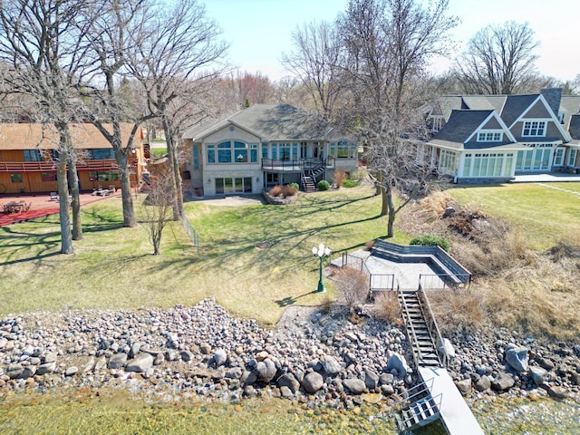 exterior space featuring a wooden deck, a sunroom, and stairway