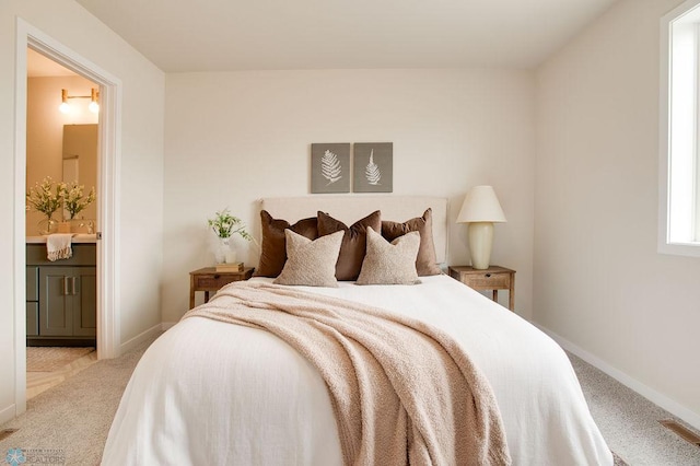 carpeted bedroom featuring connected bathroom