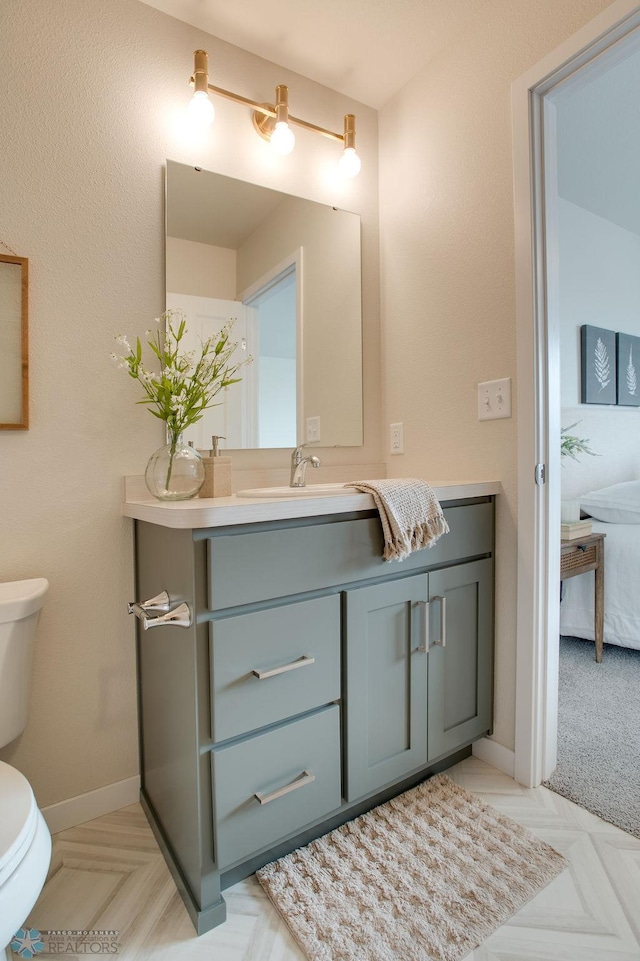 bathroom with vanity and toilet