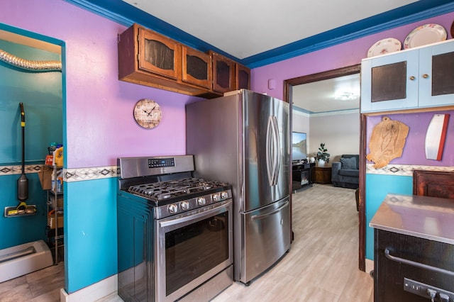 kitchen with light hardwood / wood-style floors, crown molding, and stainless steel appliances