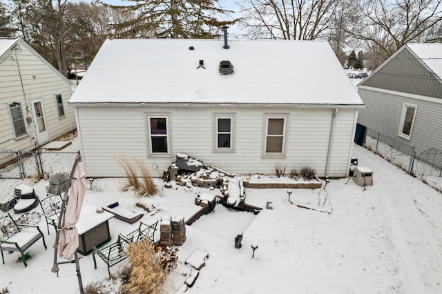 view of snow covered rear of property