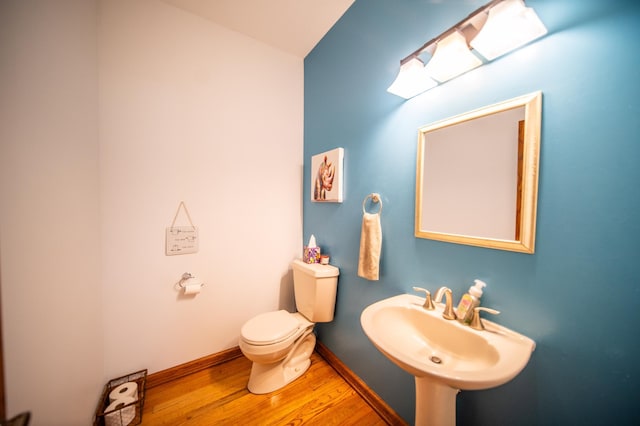 bathroom with sink, hardwood / wood-style floors, and toilet