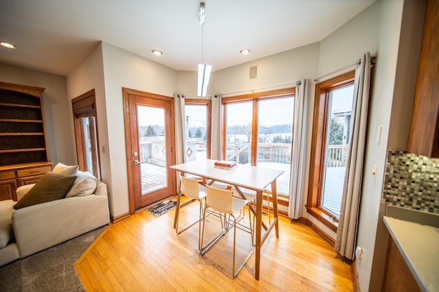 dining area with plenty of natural light and light hardwood / wood-style flooring