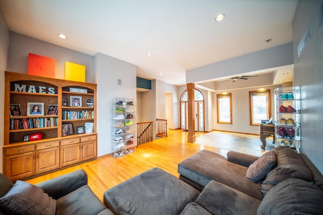 living room featuring ceiling fan and light wood-type flooring