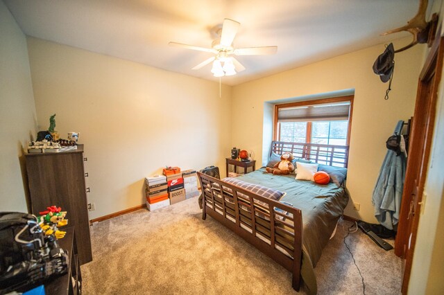 bedroom with light carpet and ceiling fan