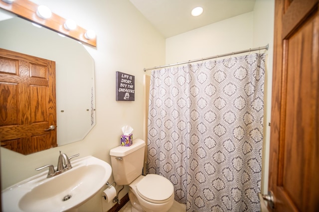 bathroom featuring toilet and sink