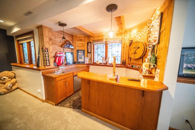 bar featuring beamed ceiling, wooden counters, decorative light fixtures, and dark carpet