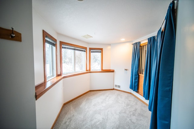 unfurnished room featuring light colored carpet