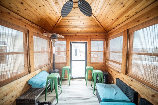 sunroom with lofted ceiling and wood ceiling