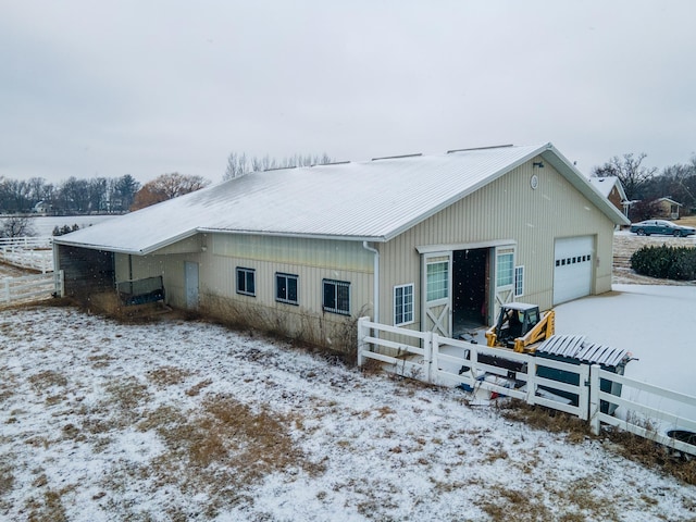 snow covered property featuring a garage