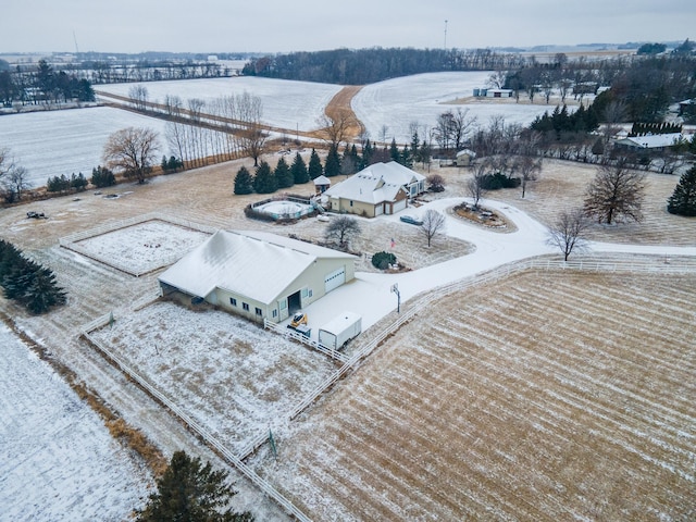 snowy aerial view featuring a rural view