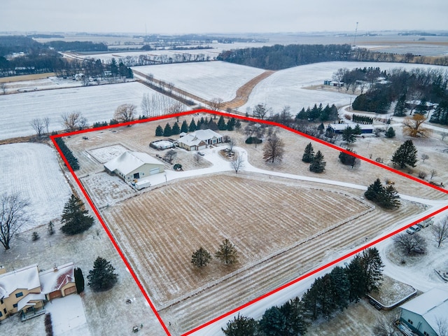 snowy aerial view featuring a rural view