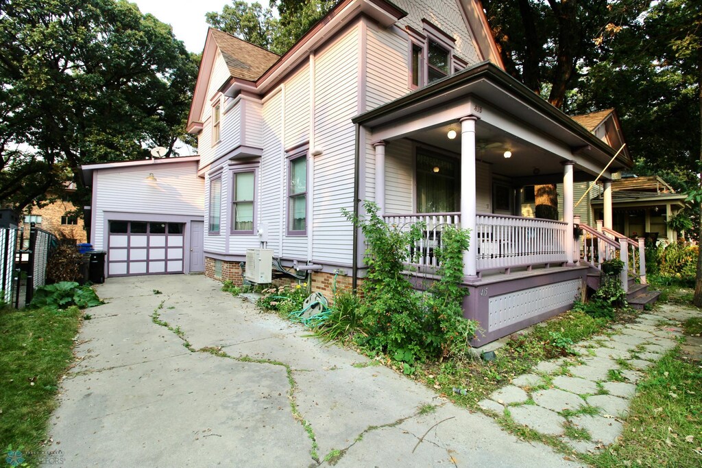 view of front of property featuring covered porch, an outbuilding, and a garage