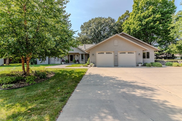 view of front of house featuring a garage and a front lawn