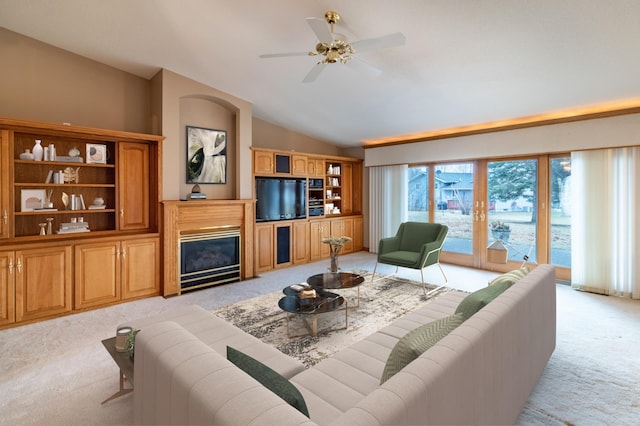 living room featuring ceiling fan, light carpet, and vaulted ceiling