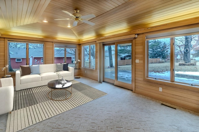 sunroom with ceiling fan, lofted ceiling, and wood ceiling