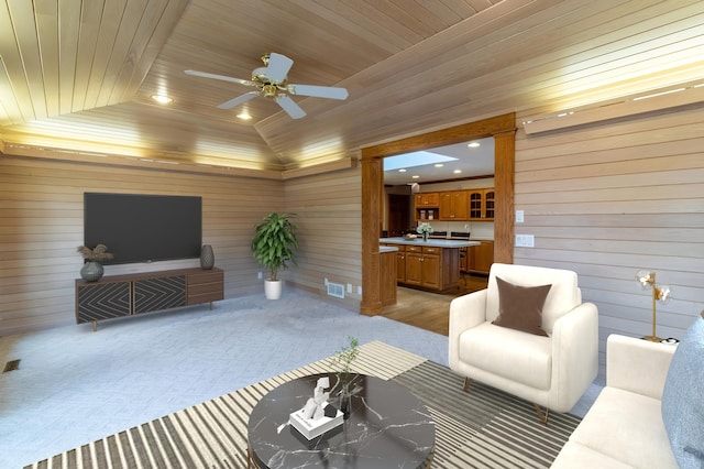 carpeted living room featuring ceiling fan, wooden walls, wooden ceiling, and lofted ceiling