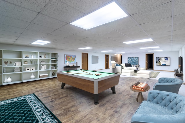 recreation room with wood-type flooring, a paneled ceiling, and pool table