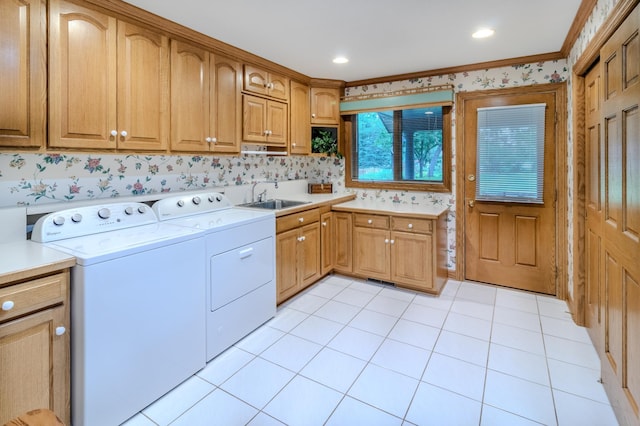 washroom featuring cabinets, ornamental molding, sink, separate washer and dryer, and light tile patterned flooring