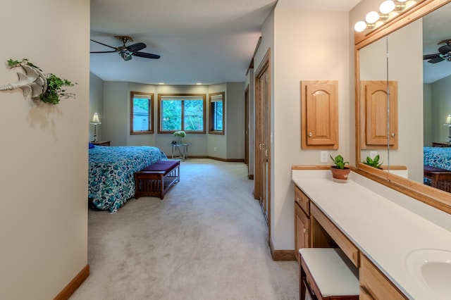 bathroom with ceiling fan and vanity