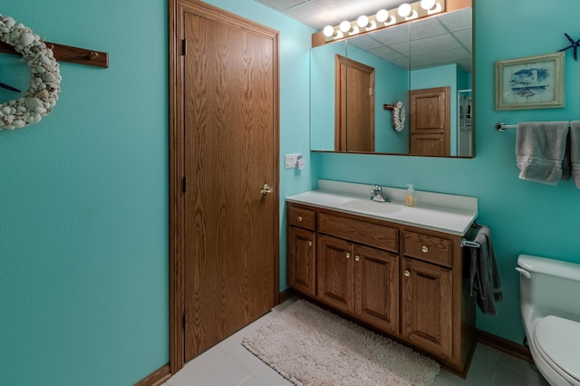 bathroom featuring tile patterned flooring, vanity, and toilet