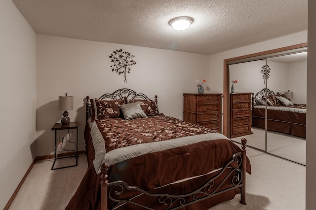 carpeted bedroom featuring a textured ceiling and a closet