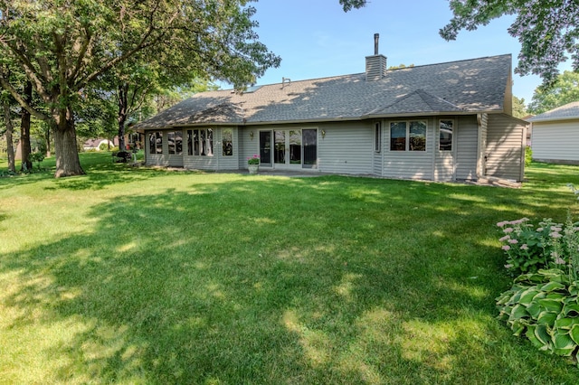 rear view of property with a yard