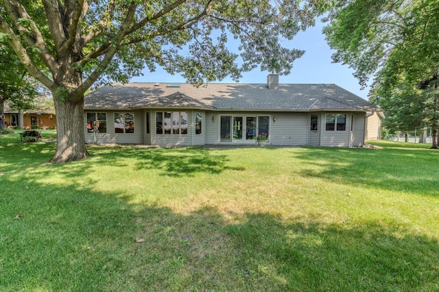 rear view of property featuring a yard