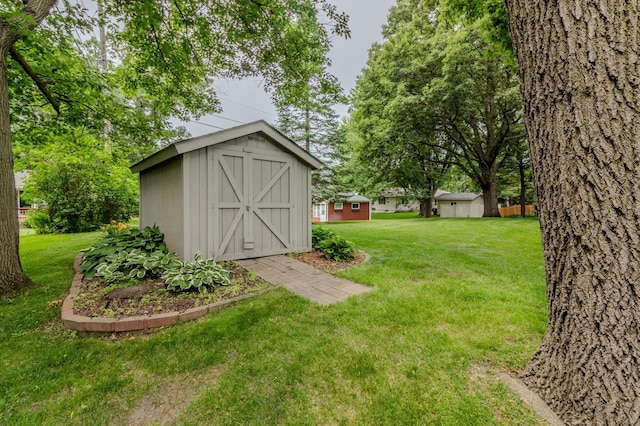 view of outbuilding featuring a yard