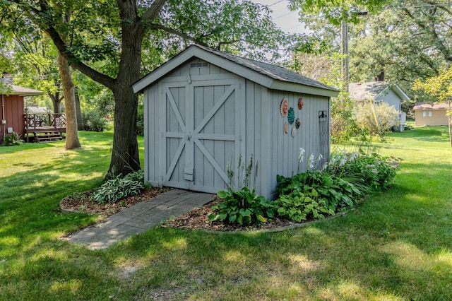 view of outbuilding featuring a lawn