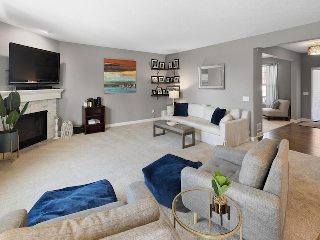 living room featuring light colored carpet and a brick fireplace