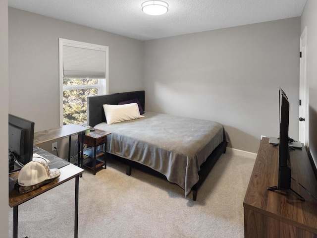 carpeted bedroom with a textured ceiling