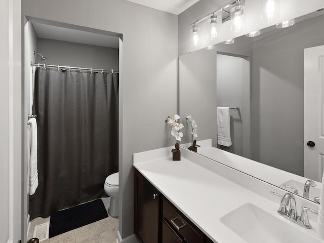 bathroom featuring vanity, tile patterned flooring, toilet, and a shower with shower curtain