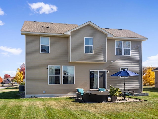 rear view of property with a yard and a patio area