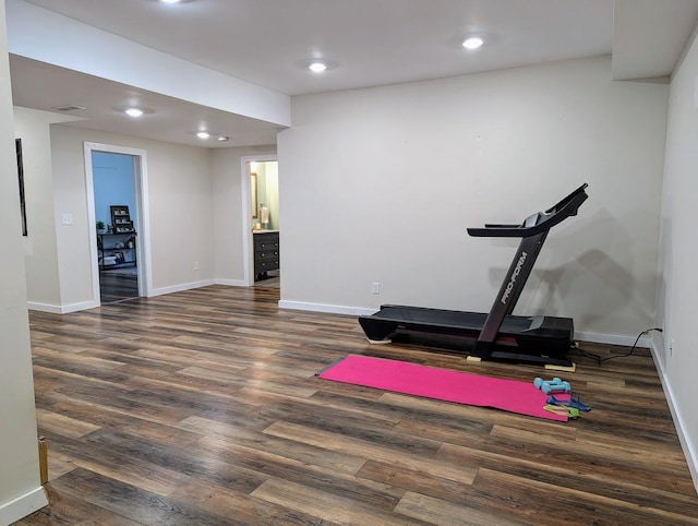 exercise room featuring dark wood-type flooring