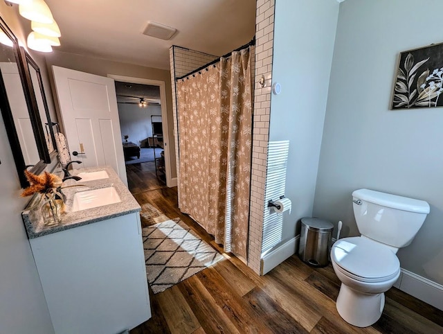 bathroom with a shower with curtain, vanity, toilet, and wood-type flooring