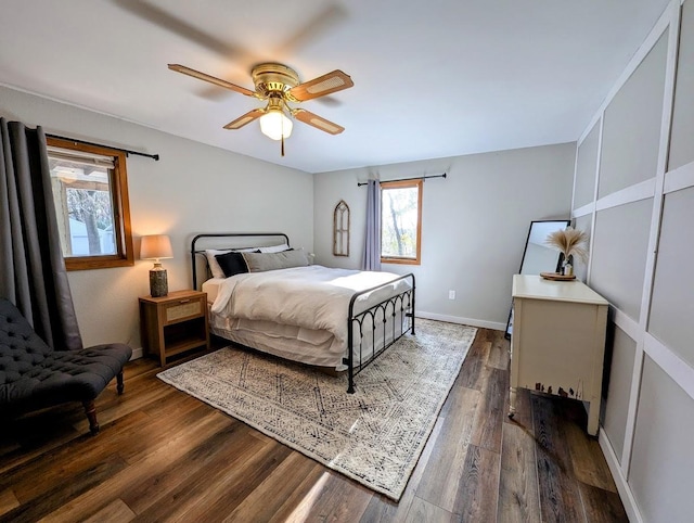 bedroom with ceiling fan and dark wood-type flooring