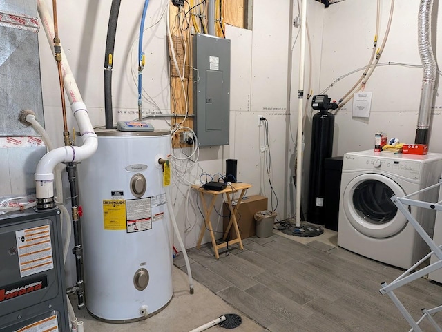 utility room with electric panel, washer / clothes dryer, and water heater