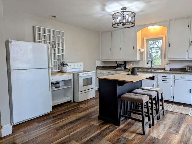 kitchen with wooden counters, white appliances, sink, white cabinets, and a chandelier