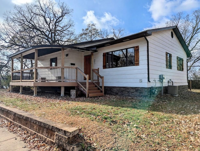 view of front of property with a porch and central AC