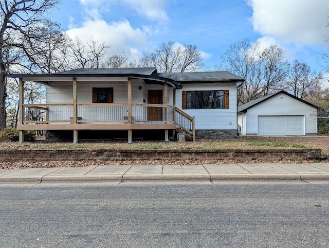 view of front of house with a garage and an outdoor structure