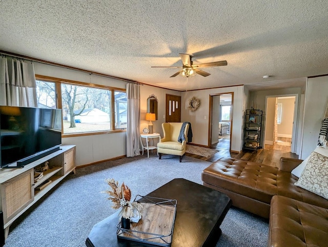 carpeted living room with a textured ceiling, a wealth of natural light, and ceiling fan