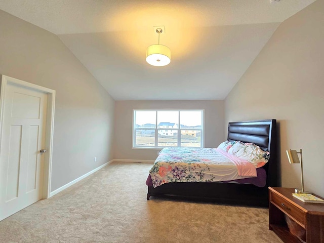 carpeted bedroom featuring vaulted ceiling