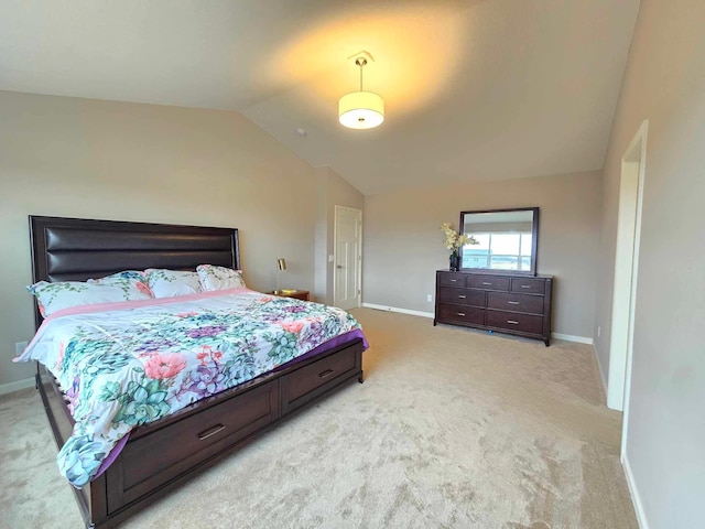 bedroom featuring light colored carpet and lofted ceiling